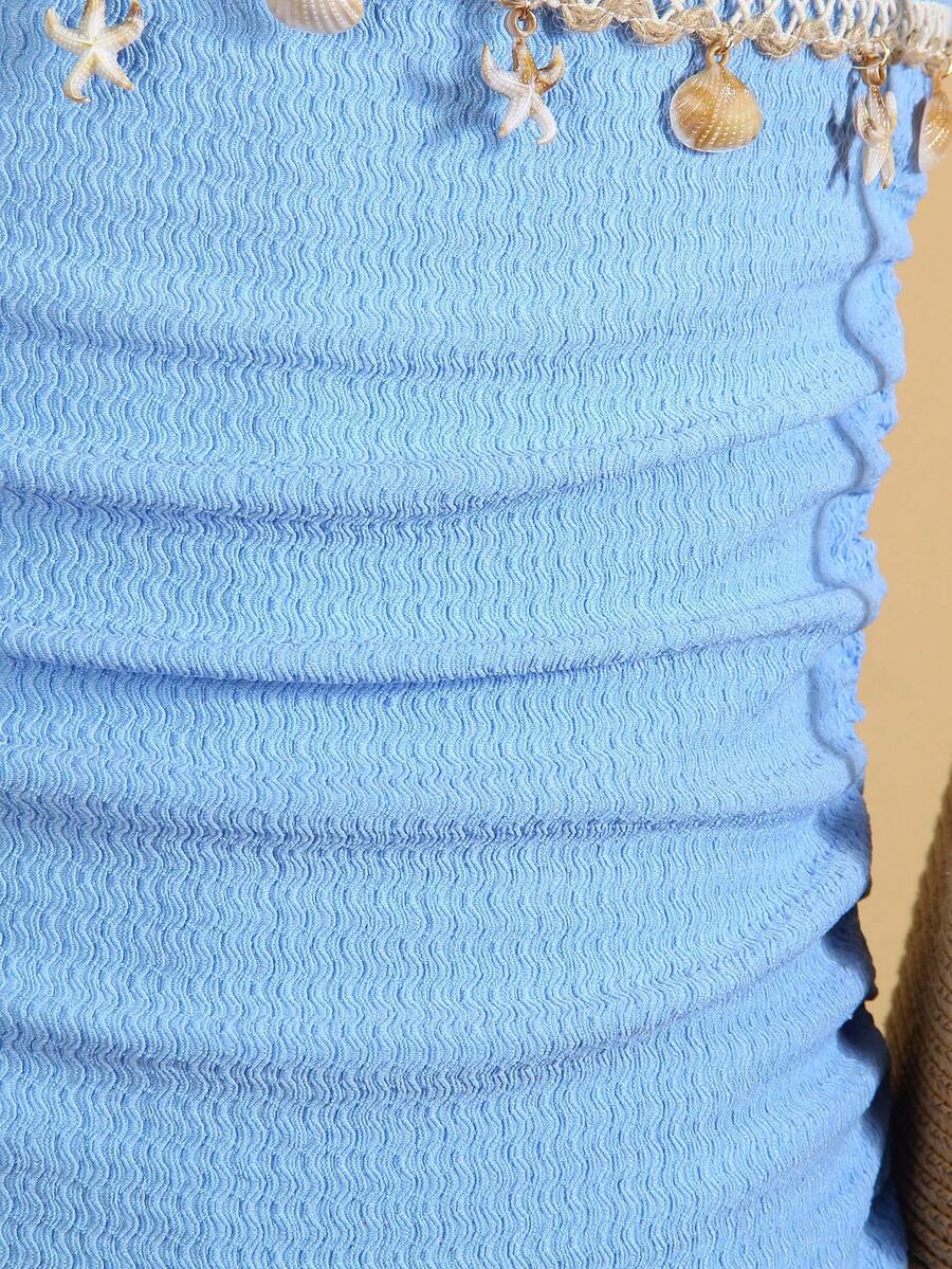 Tween girls apricot sleeveless halter mini dress with textured starfish and shell decor, shirred tiered layer, high waist, and flounce hem.