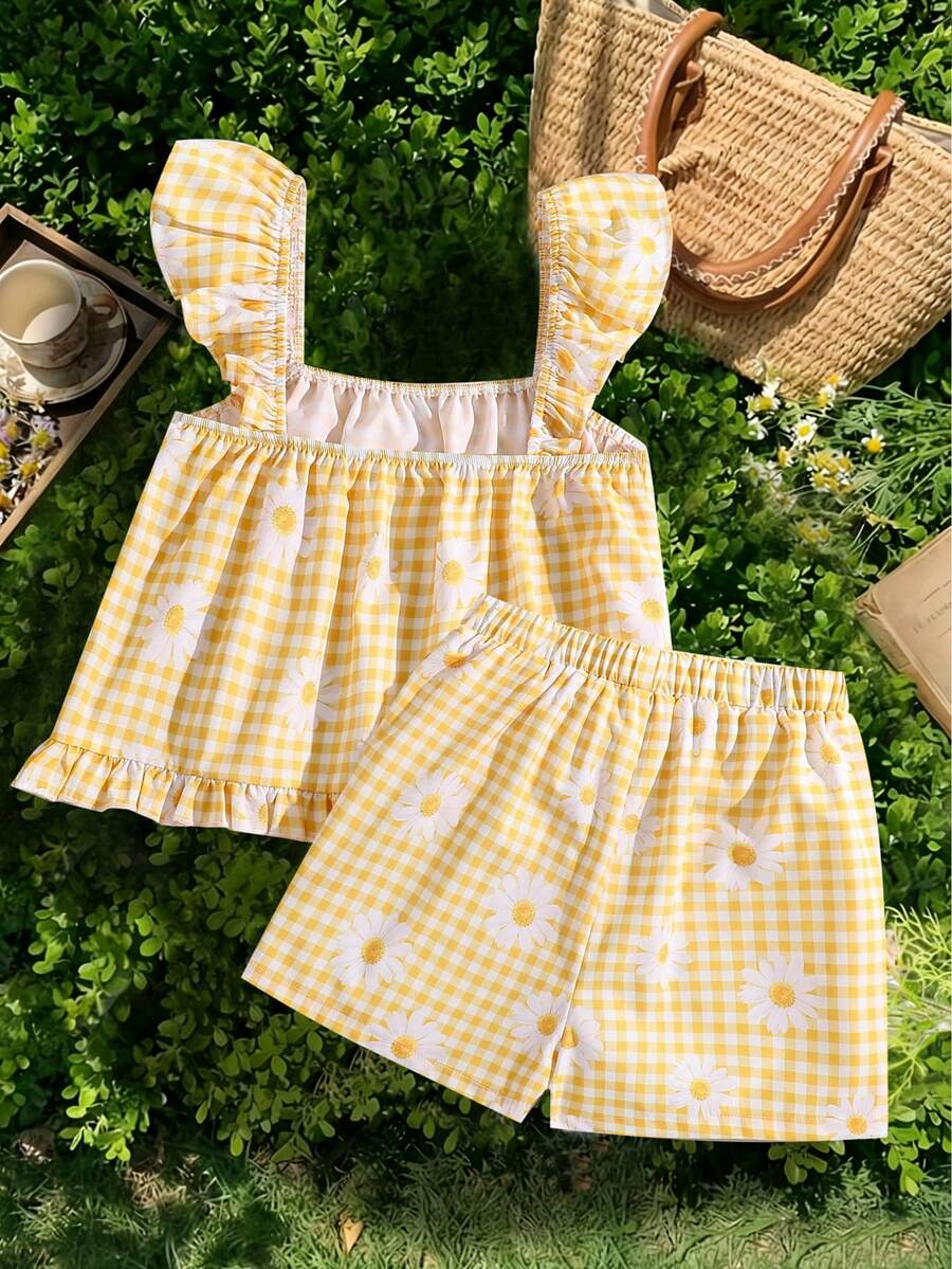 Tween girl wearing a blue and white striped sleeveless top featuring embroidery details and ruffle trim with matching shorts.