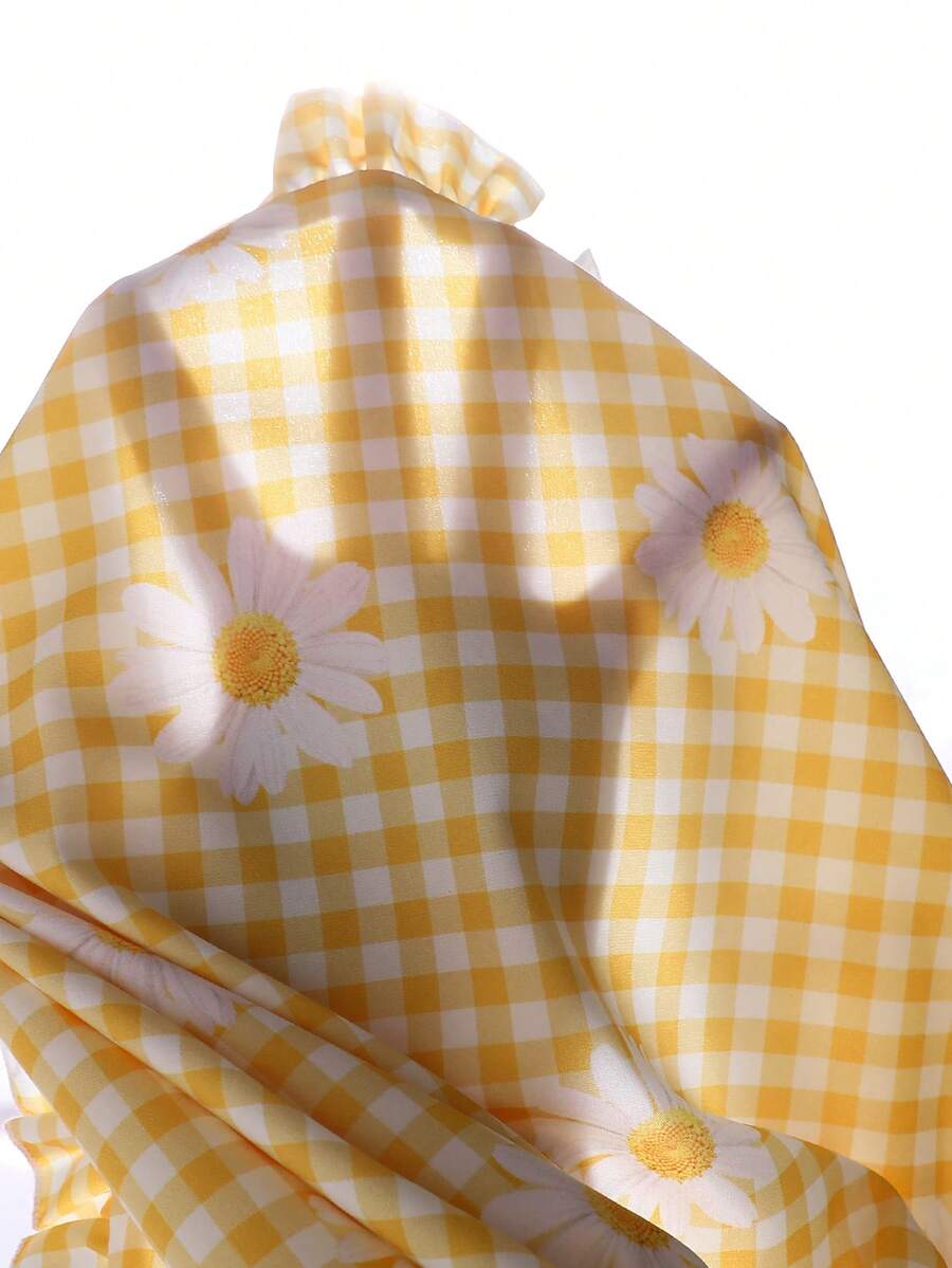 Tween girl wearing a blue and white striped sleeveless top featuring embroidery details and ruffle trim with matching shorts.