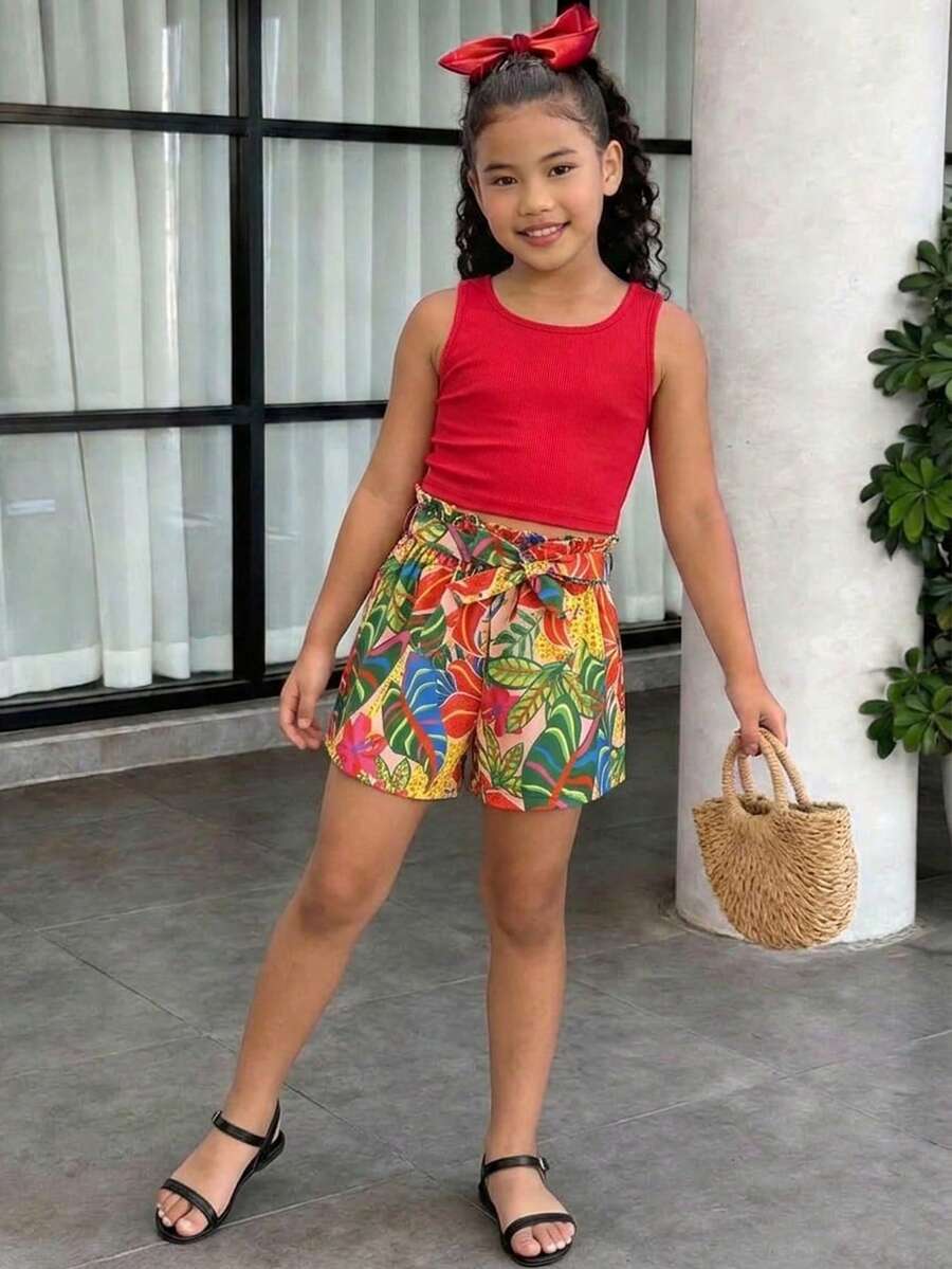 Tween girl wearing a casual 2-piece set featuring a black rib-knit scoop neck tank top and leopard print paperbag waist shorts with a matching belt.