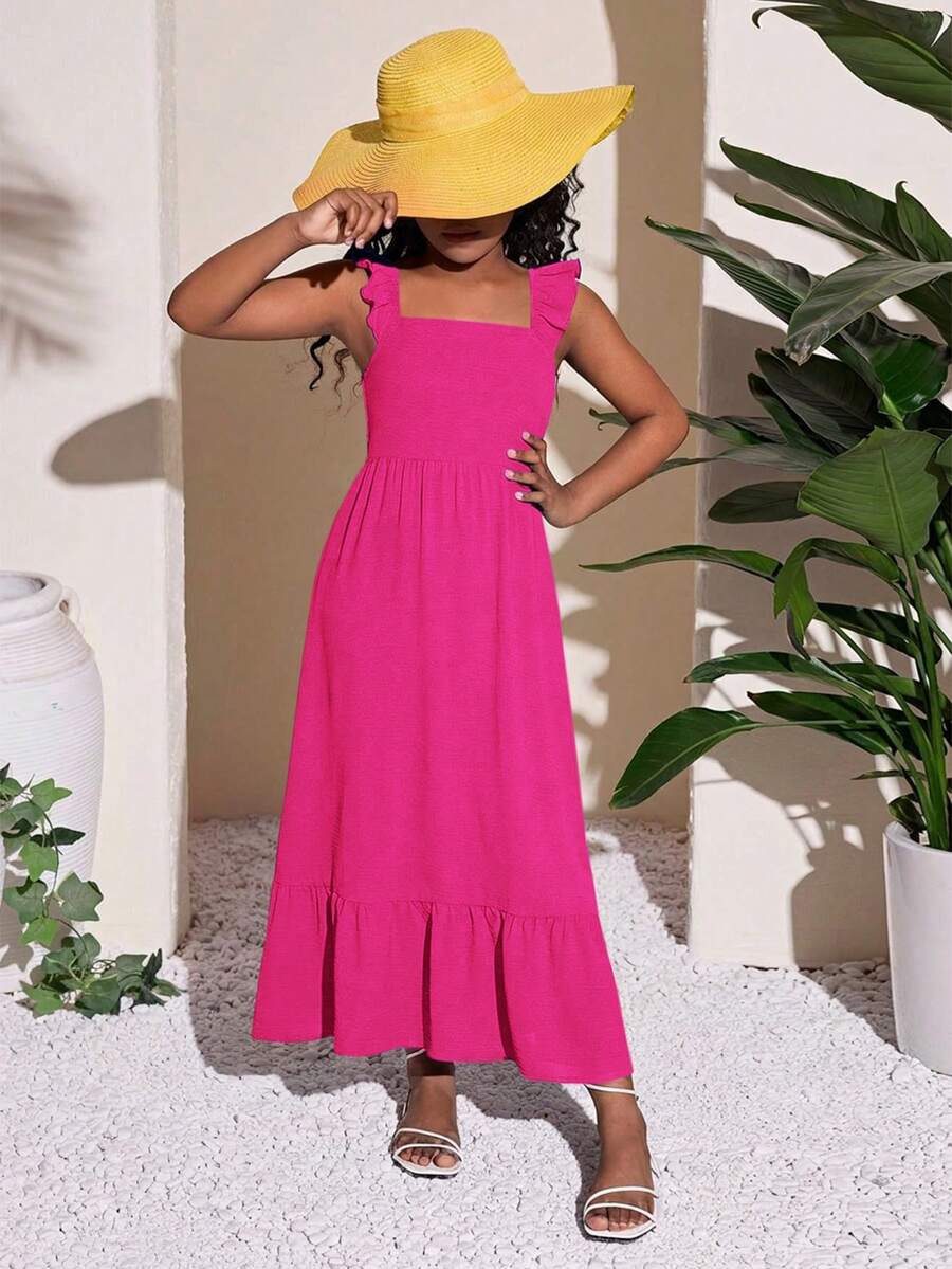 Blue floral print long vacation dress for tween girls featuring an A-line high waist silhouette with ruffle details and spaghetti straps.
