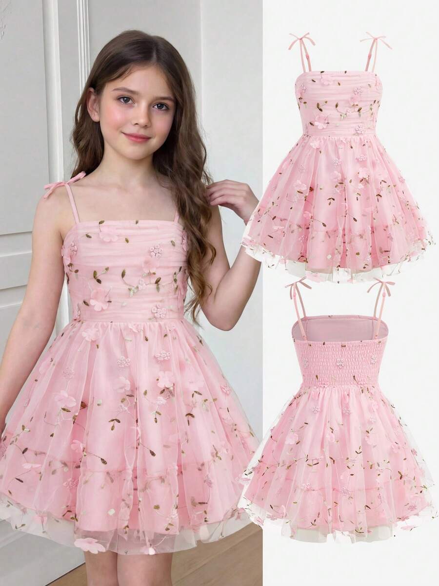 Pink floral print sleeveless cami dress for tween girls featuring spaghetti straps, ruched bust, high waist, and flared short hem.