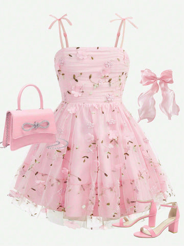 Pink floral print sleeveless cami dress for tween girls featuring spaghetti straps, ruched bust, high waist, and flared short hem.