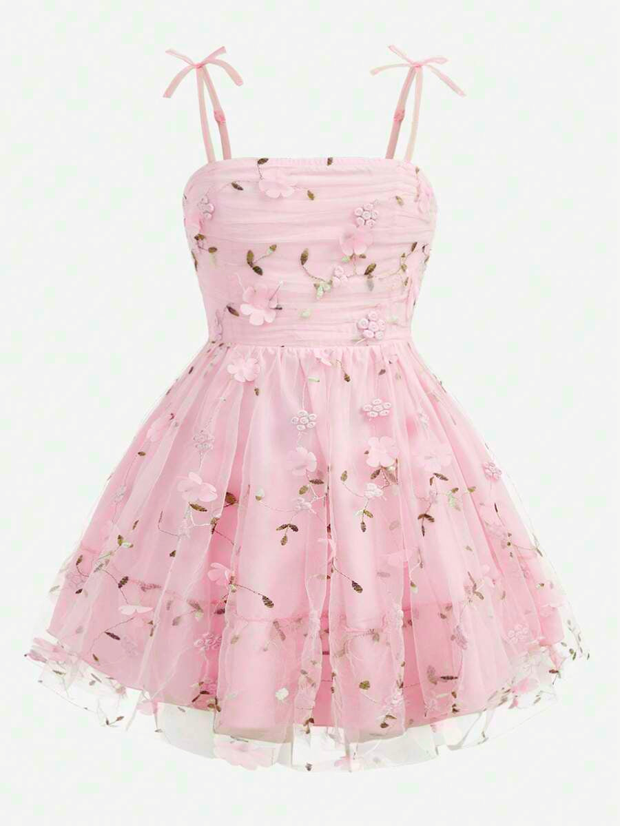 Pink floral print sleeveless cami dress for tween girls featuring spaghetti straps, ruched bust, high waist, and flared short hem.
