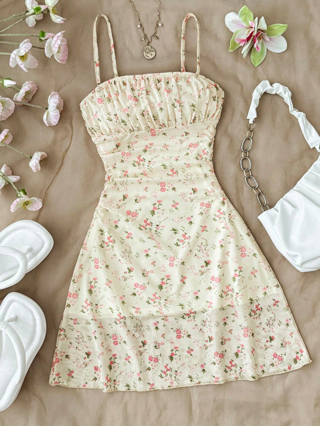 Tween girl yellow mini sundress with large pink floral hibiscus print, spaghetti straps, high waist, flared hem, and sleeveless cami style for summer beach wear