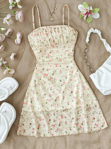 Tween girl yellow mini sundress with large pink floral hibiscus print, spaghetti straps, high waist, flared hem, and sleeveless cami style for summer beach wear