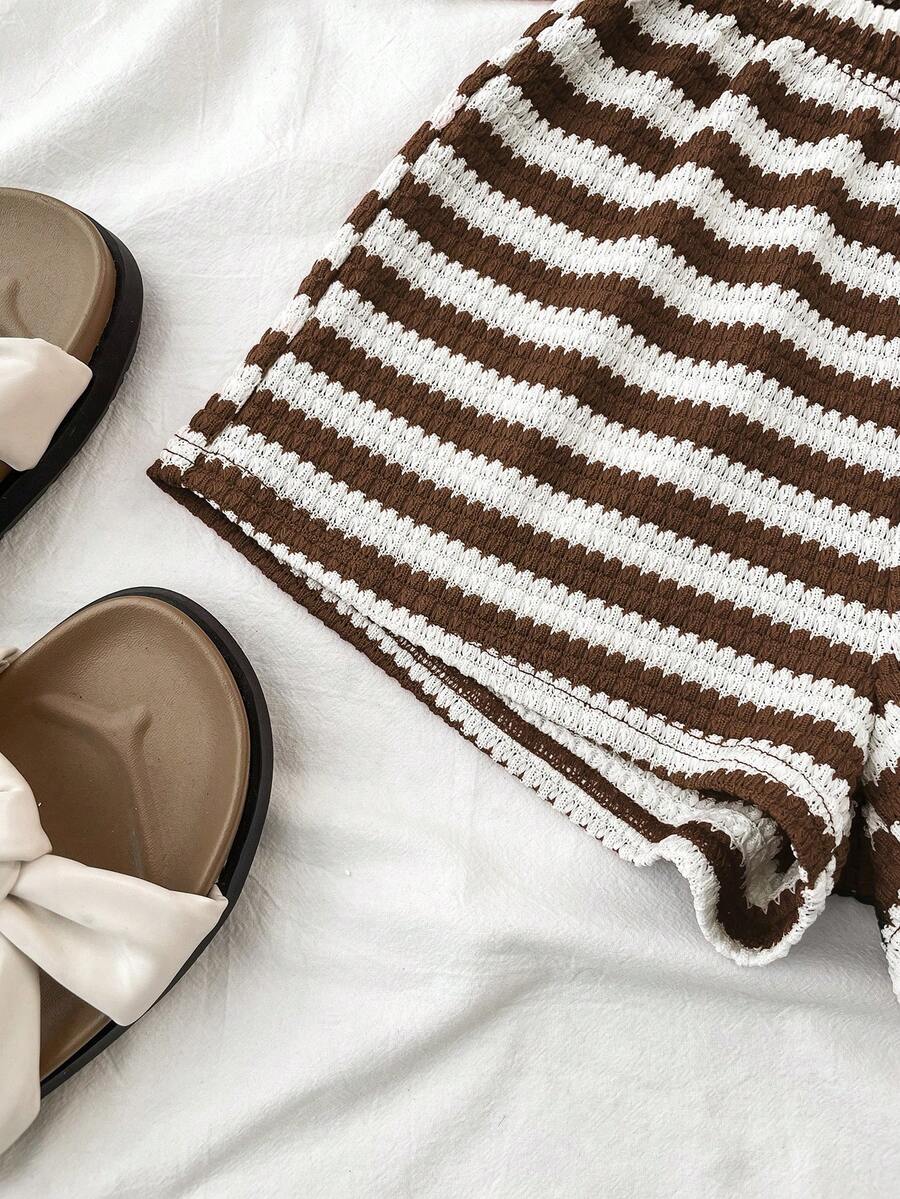 Tween girls black and white two-piece casual summer outfit featuring a rib-knit cropped top with round neck and matching shorts with contrast piping.