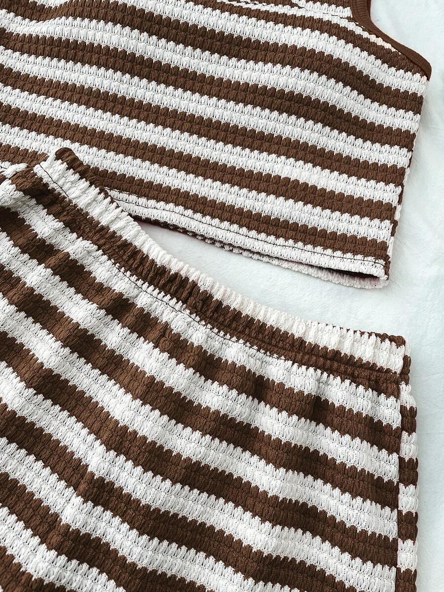 Tween girls black and white two-piece casual summer outfit featuring a rib-knit cropped top with round neck and matching shorts with contrast piping.