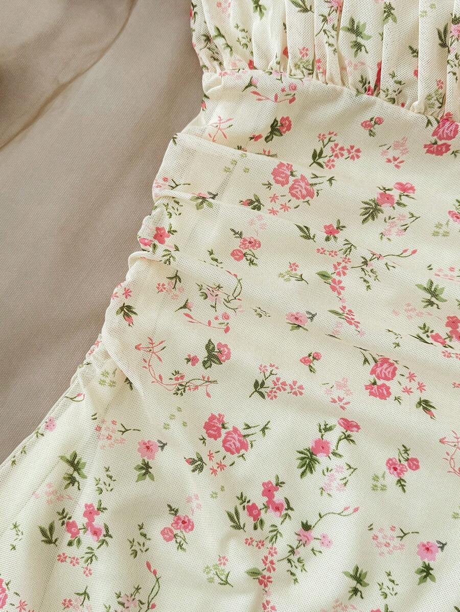 Tween girl yellow mini sundress with large pink floral hibiscus print, spaghetti straps, high waist, flared hem, and sleeveless cami style for summer beach wear
