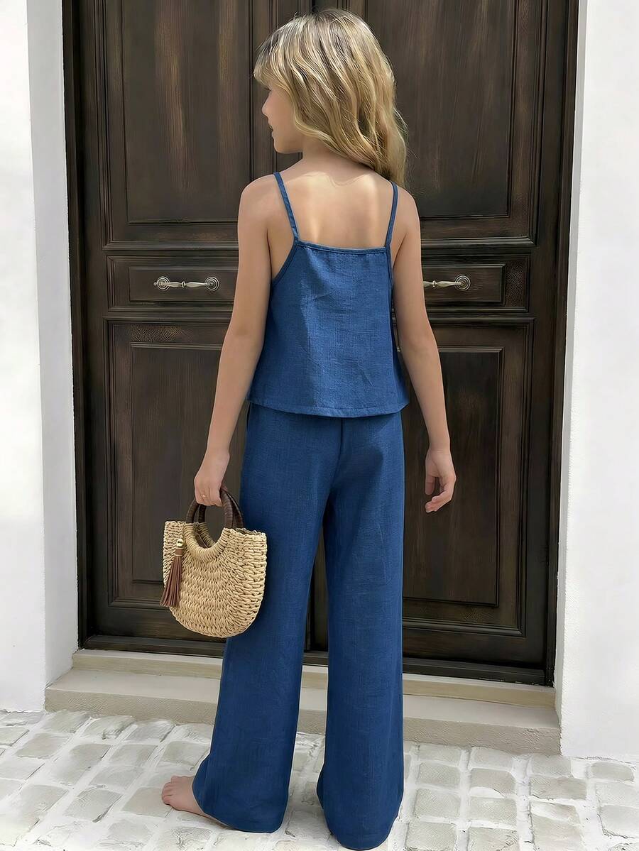 Tween girls blue 2-piece vacation outfit set featuring a tiered ruffle spaghetti strap camisole and loose high-waist pants.