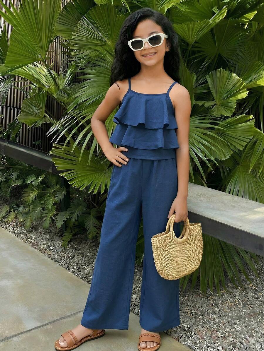 Tween girls blue 2-piece vacation outfit set featuring a tiered ruffle spaghetti strap camisole and loose high-waist pants.
