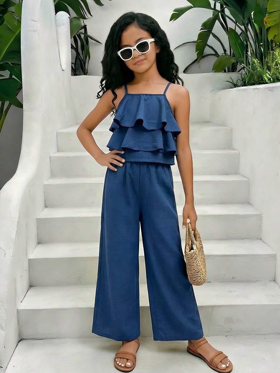 Tween girls blue 2-piece vacation outfit set featuring a tiered ruffle spaghetti strap camisole and loose high-waist pants.