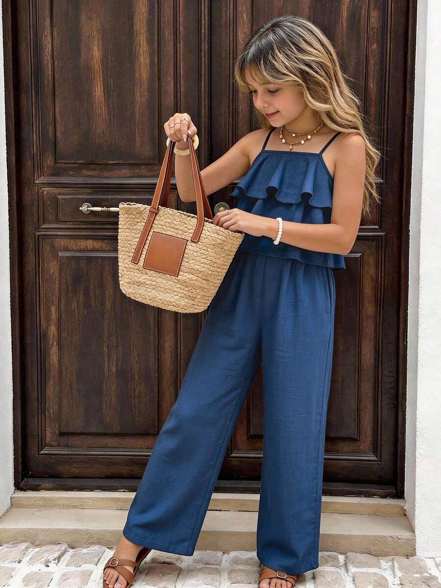 Tween girls blue 2-piece vacation outfit set featuring a tiered ruffle spaghetti strap camisole and loose high-waist pants.