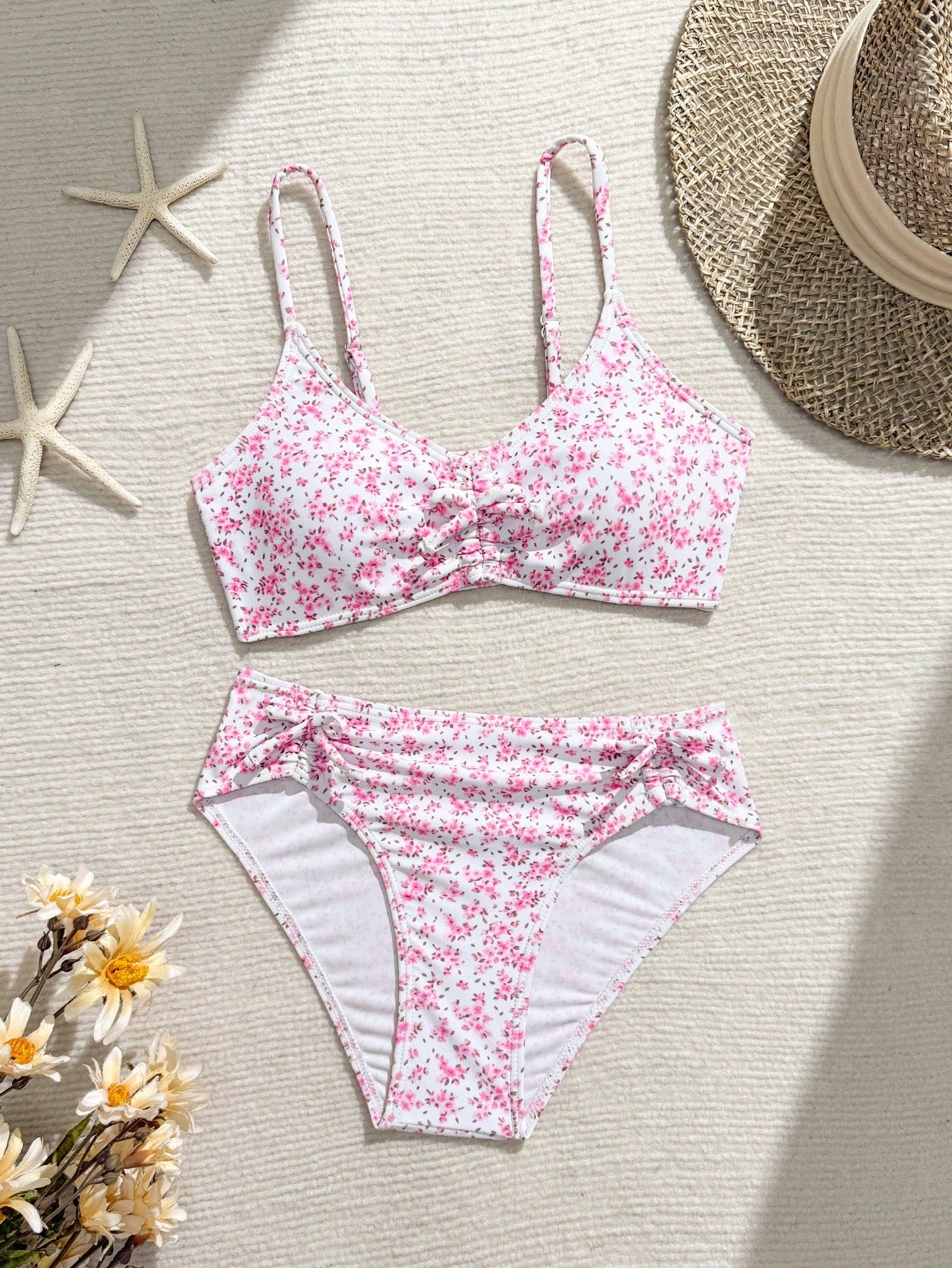 Tween girls 2-piece ditsy floral bikini set featuring a spaghetti strap top with center string detail and matching bottoms with side strings, designed for swimming, vacation, and summer wear.