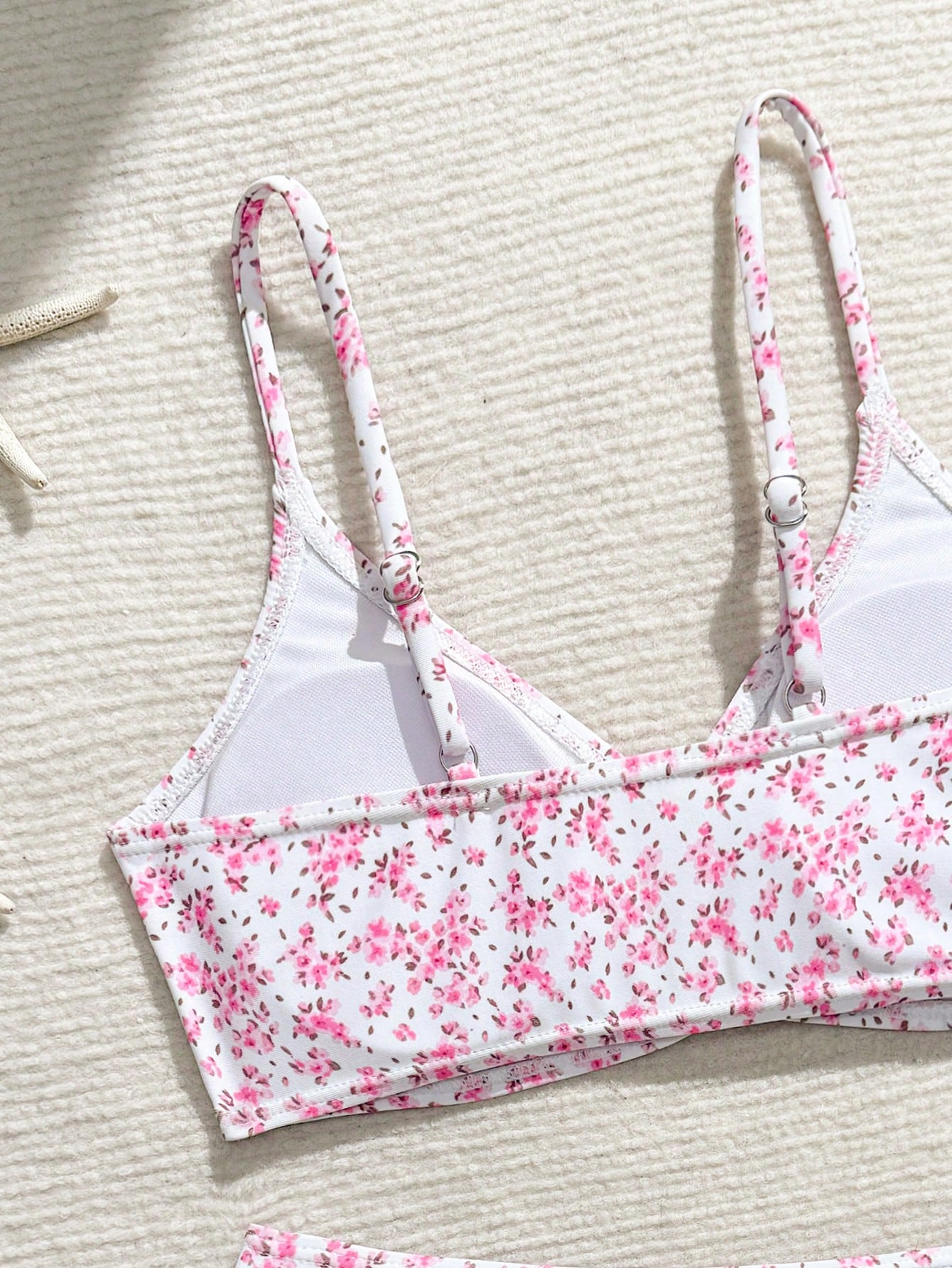 Tween girls 2-piece ditsy floral bikini set featuring a spaghetti strap top with center string detail and matching bottoms with side strings, designed for swimming, vacation, and summer wear.