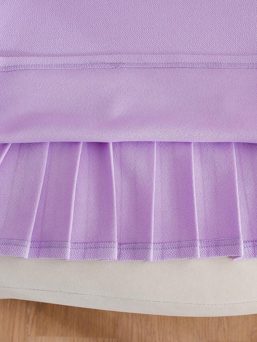 Tween girls apricot short-sleeve pleated smock dress with 3D bow decor and round neckline.