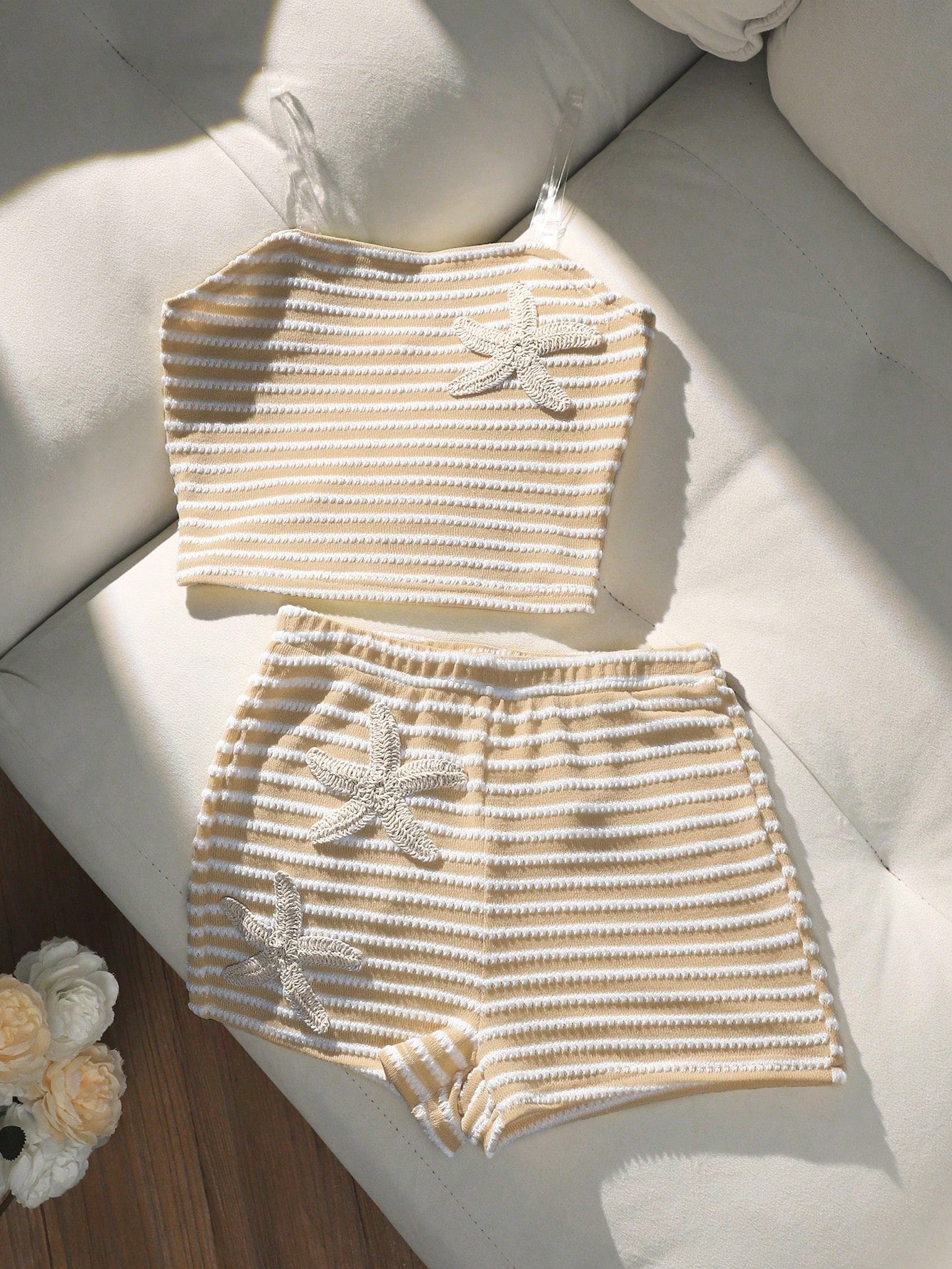 Tween girls black and white striped two-piece set featuring a spaghetti strap micro crop tank top with lettuce trim and ruffle hem paired with matching slim fit shorts.