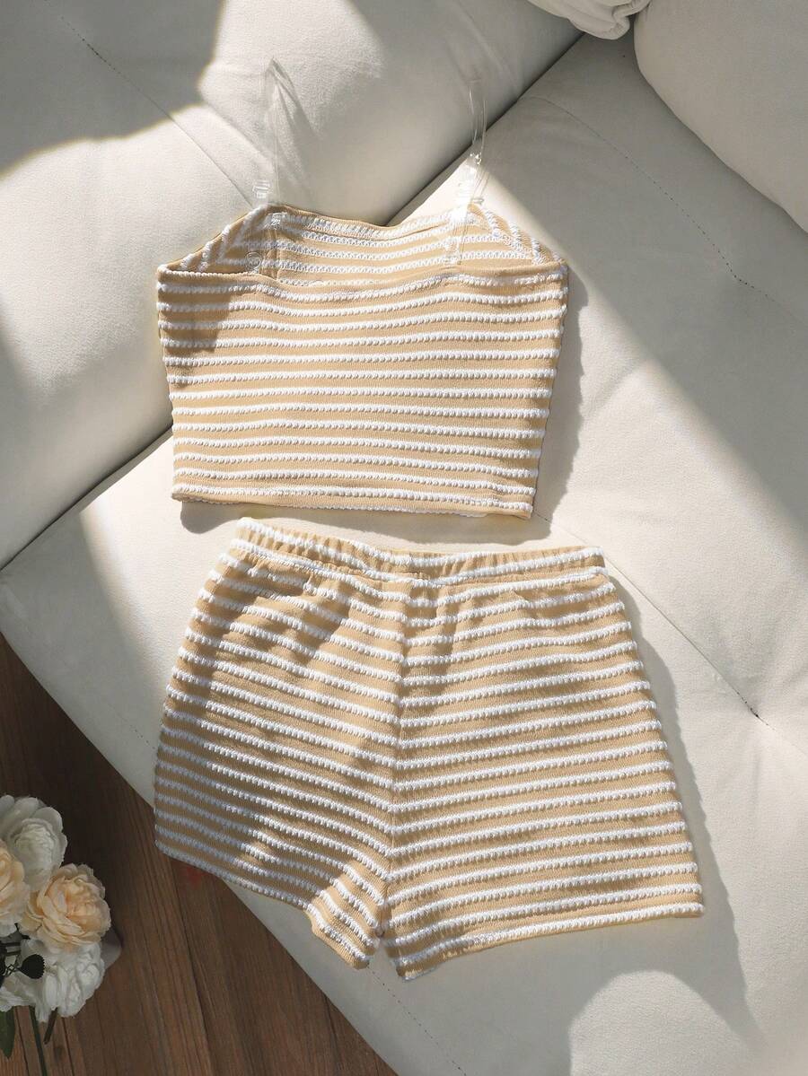 Tween girls black and white striped two-piece set featuring a spaghetti strap micro crop tank top with lettuce trim and ruffle hem paired with matching slim fit shorts.