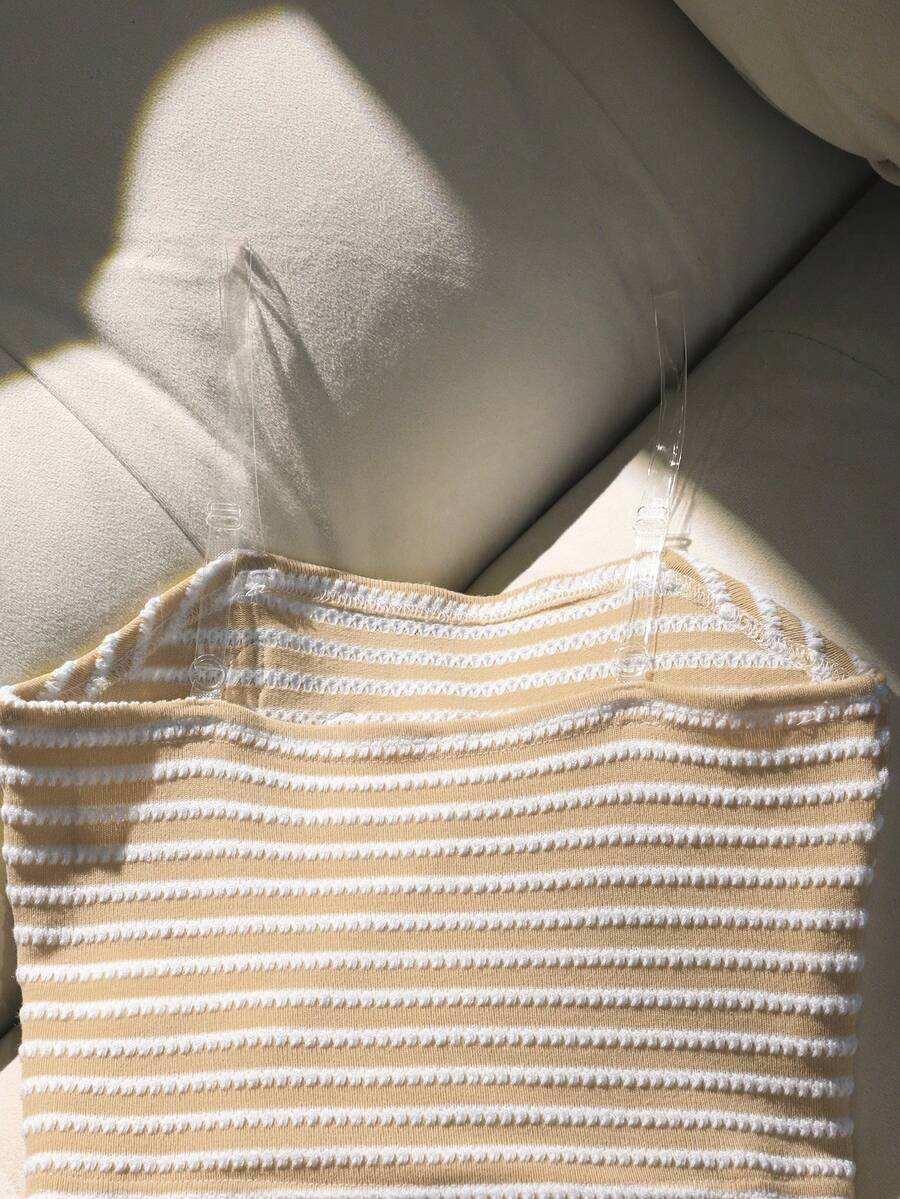 Tween girls black and white striped two-piece set featuring a spaghetti strap micro crop tank top with lettuce trim and ruffle hem paired with matching slim fit shorts.