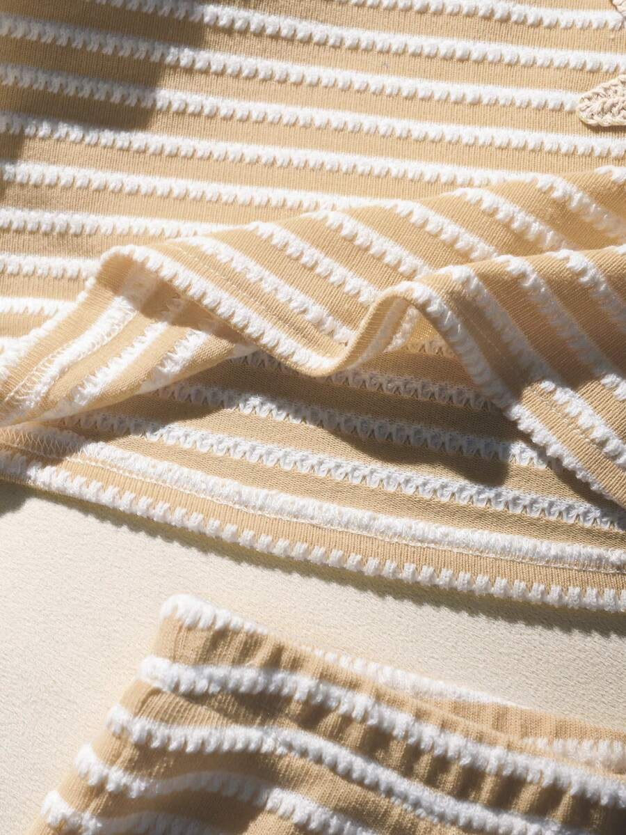 Tween girls black and white striped two-piece set featuring a spaghetti strap micro crop tank top with lettuce trim and ruffle hem paired with matching slim fit shorts.