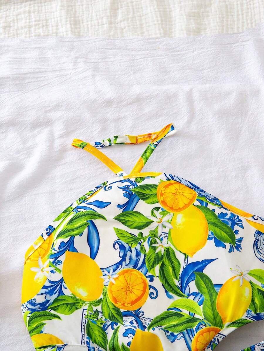 Tween girls floral halter dress with backless sleeveless design, belted high waist, shirred details, appliques, and flared A-line midi silhouette for summer vacation or graduation outfit.