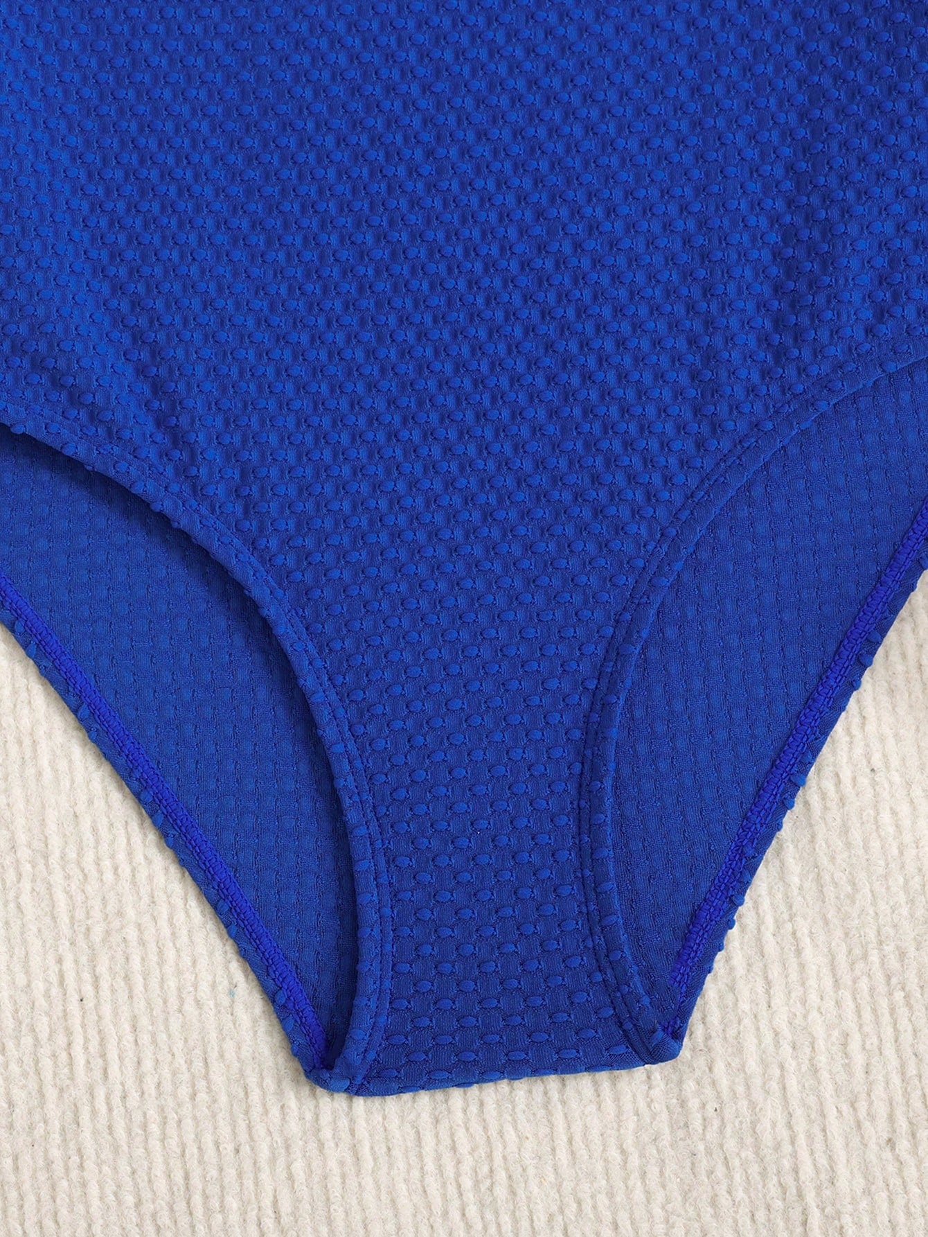Blue colorblock one-piece swimsuit for tween girls with all-over print, contrast piping, spaghetti straps, and lined high-stretch fabric for beach or pool wear.