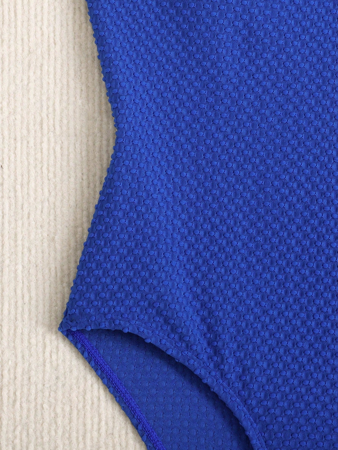 Blue colorblock one-piece swimsuit for tween girls with all-over print, contrast piping, spaghetti straps, and lined high-stretch fabric for beach or pool wear.