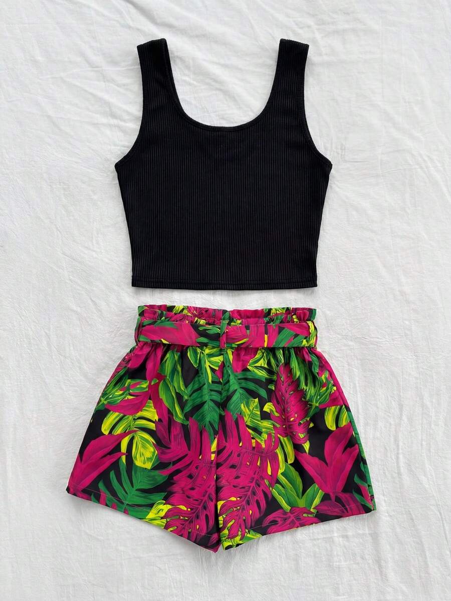 Tween girl wearing a casual 2-piece set featuring a black rib-knit scoop neck tank top and leopard print paperbag waist shorts with a matching belt.