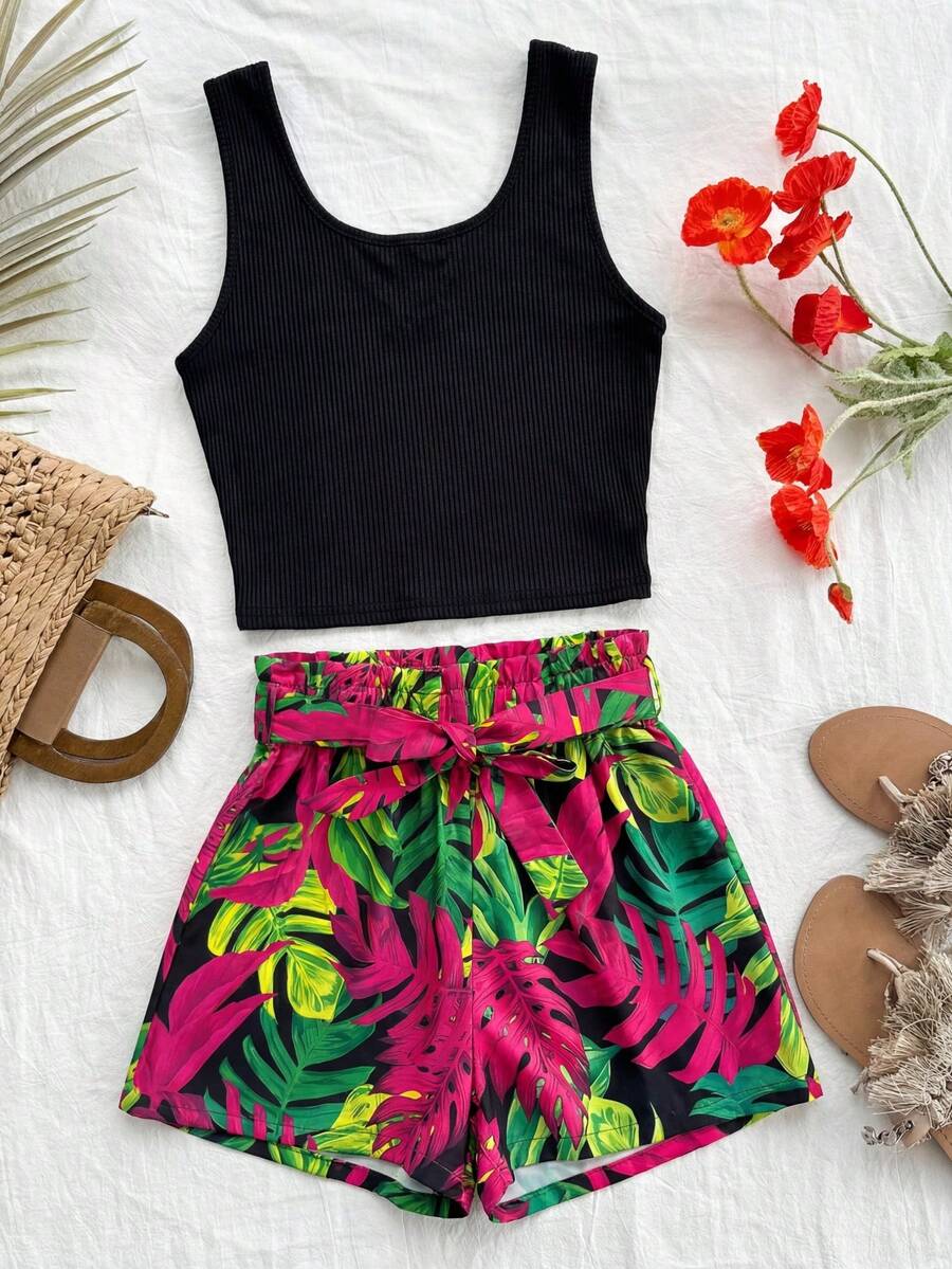 Tween girl wearing a casual 2-piece set featuring a black rib-knit scoop neck tank top and leopard print paperbag waist shorts with a matching belt.