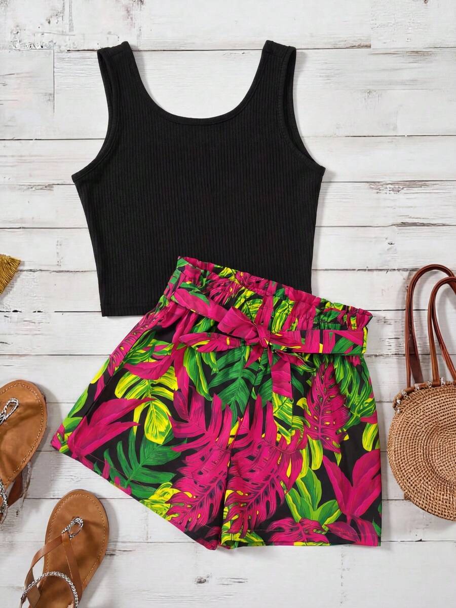 Tween girl wearing a casual 2-piece set featuring a black rib-knit scoop neck tank top and leopard print paperbag waist shorts with a matching belt.