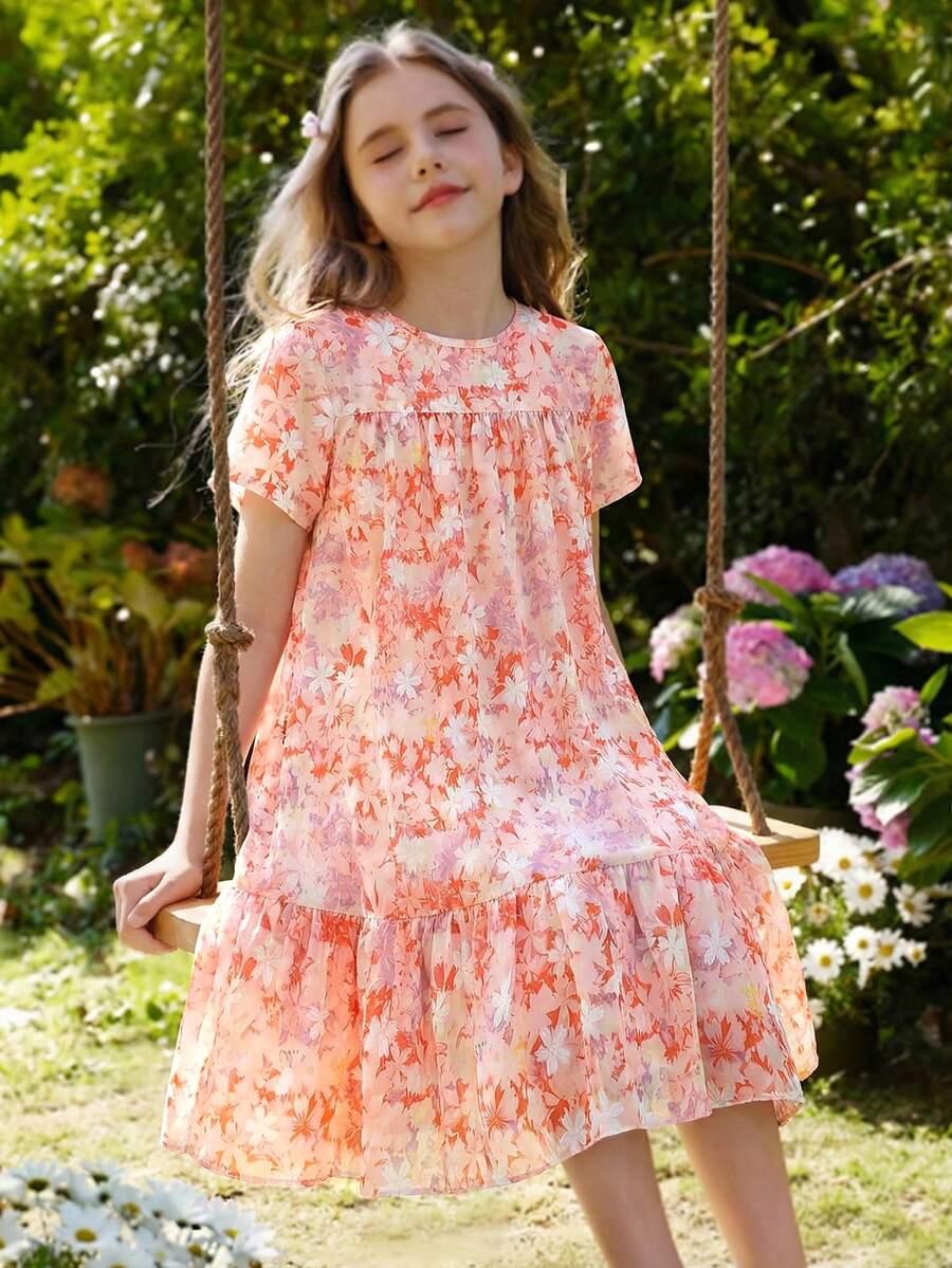Tween girl wearing an Army Green textured short sleeve smock midi dress with round neck and ruffle flounce hem.