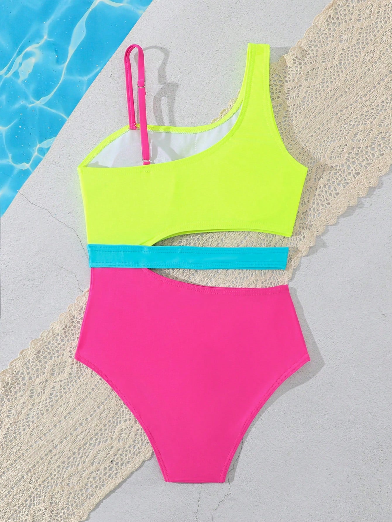 Purple tween girls one-piece swimsuit with asymmetrical neckline, cut-out waist, striped pattern, fitted silhouette, and lined body.