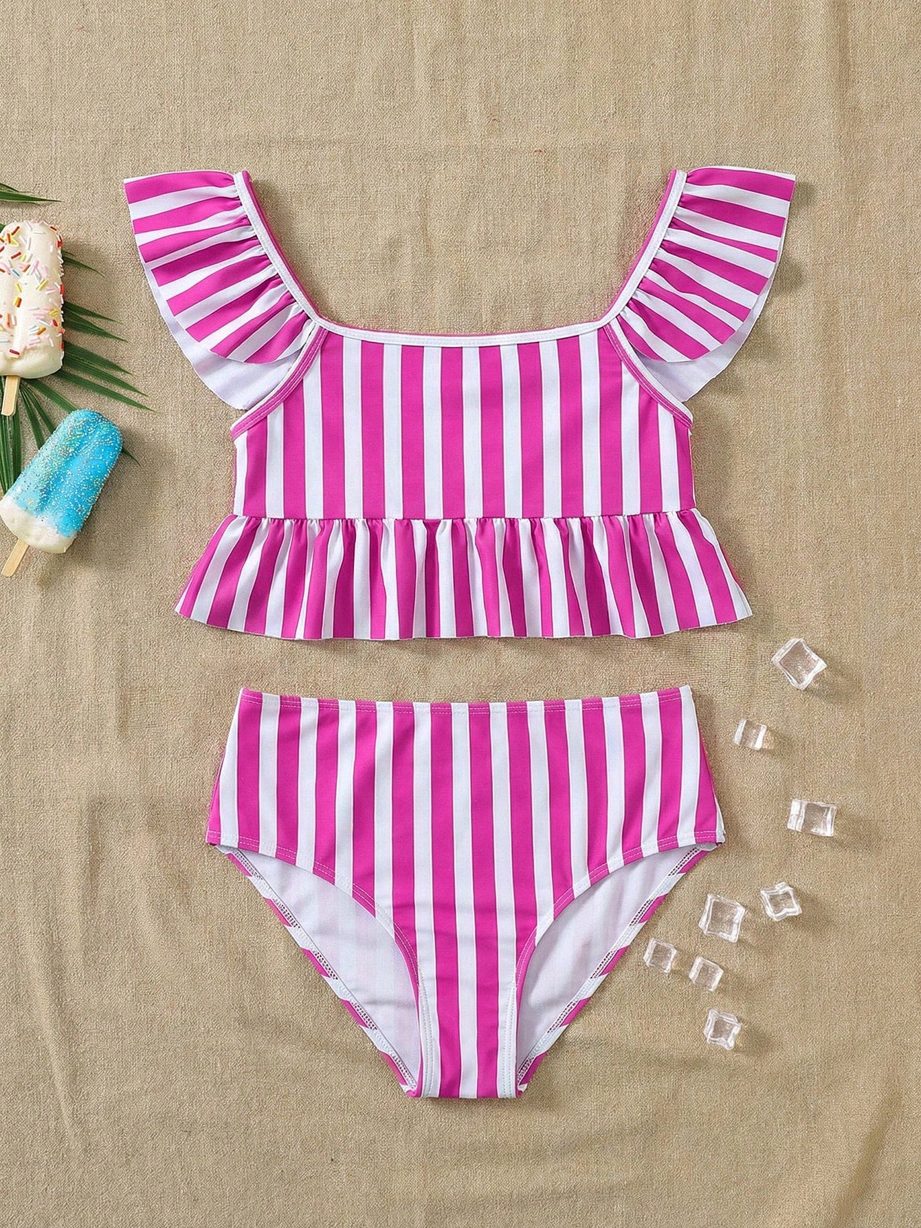 Girls striped tankini swimwear set with ruffle detail, square neckline, wireless top, and high-waist lined bottoms for beach and vacation wear.