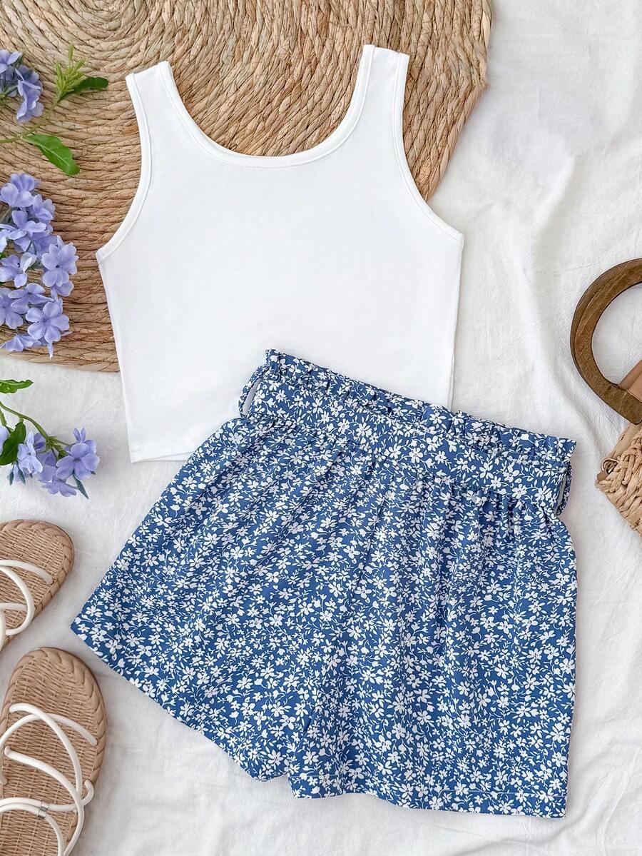 Tween girl summer two-piece outfit featuring a white scoop neck tank top and green ditsy floral print paperbag waist shorts with belt.