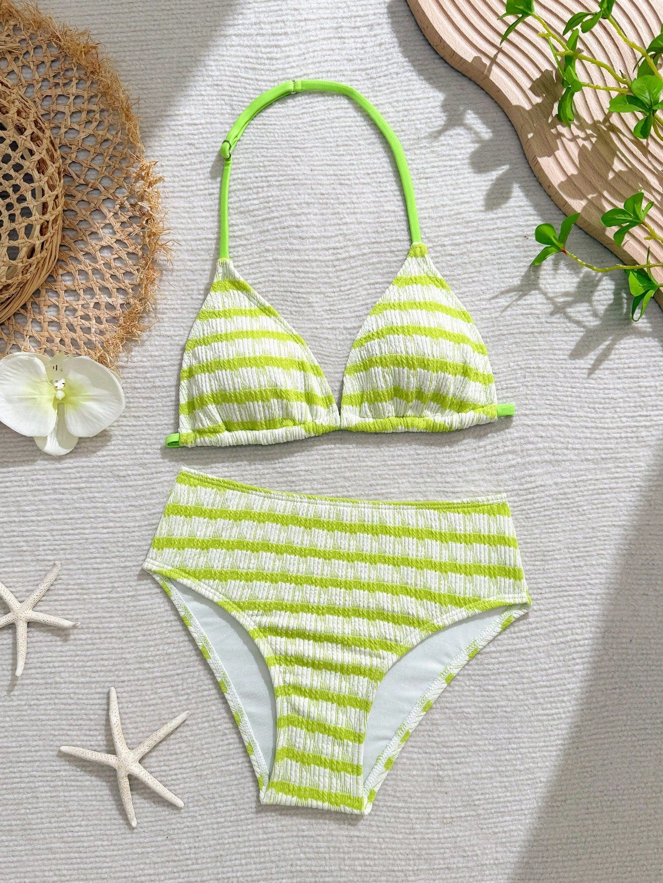 Tween girls blue and white striped two-piece bikini set with halter triangle top and mid-waist short bikini bottoms for beach and vacation swimwear.