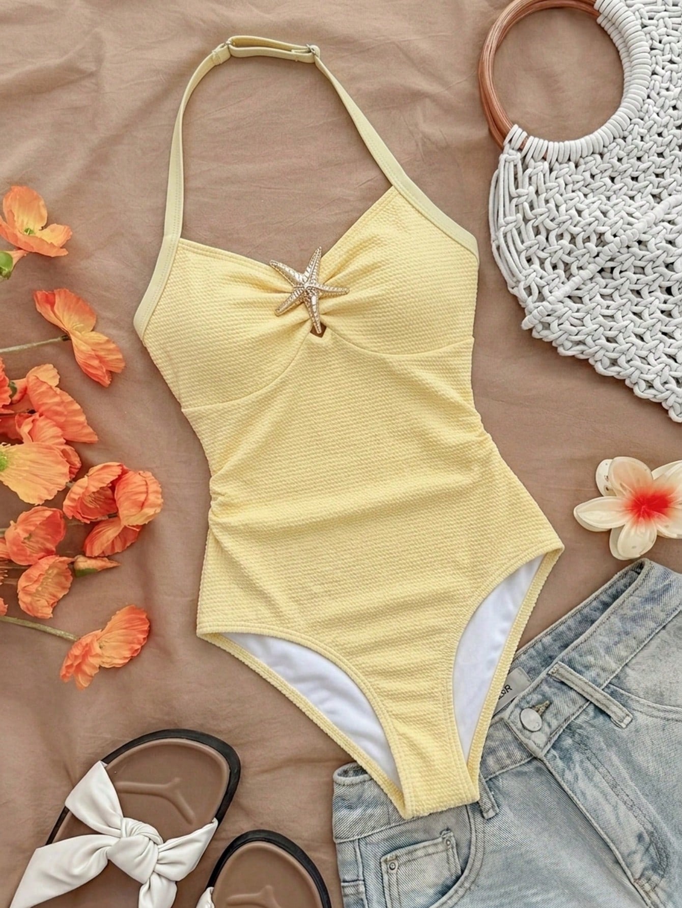 Pink textured halter one-piece swimsuit for tween girls with V-neck, tie strap, starfish and shell tassel accents, and lined body.
