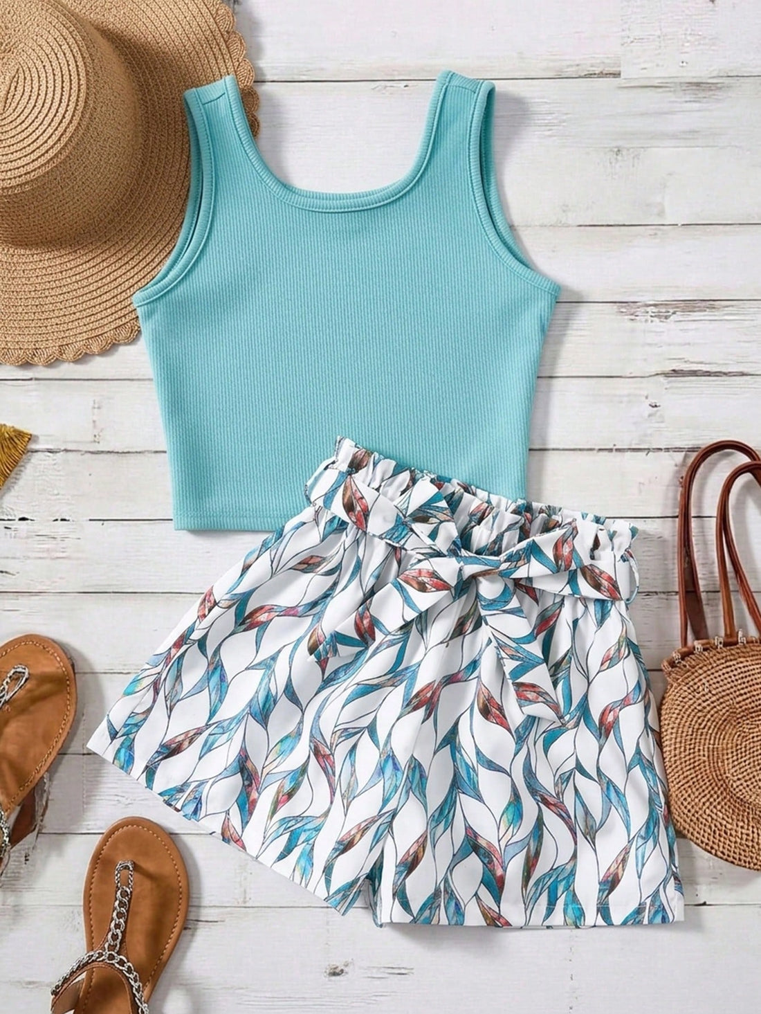 Tween girls 2-piece summer set featuring a turquoise blue ribbed tank top and tropical leaf pattern belted shorts.