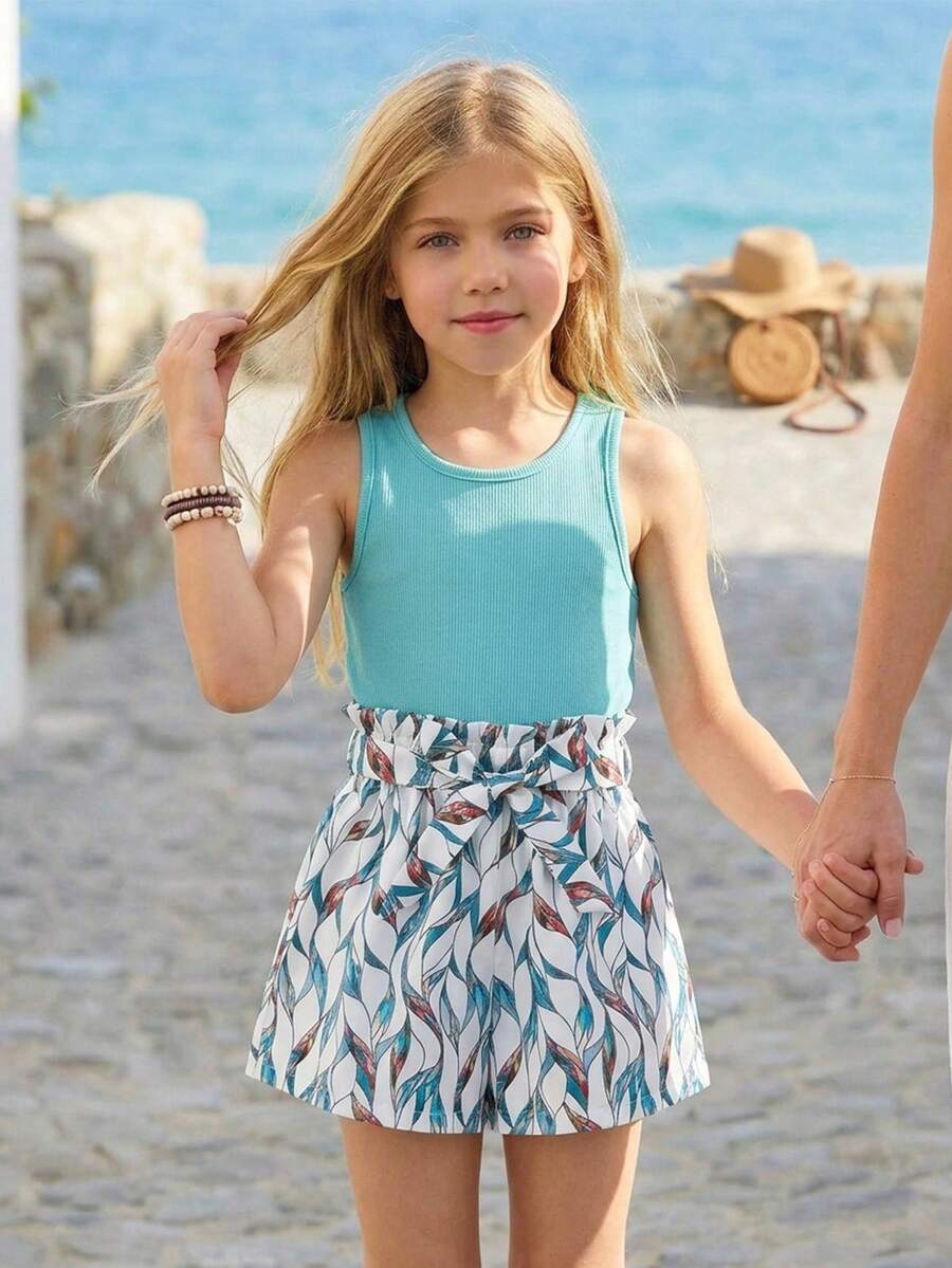 Tween girls 2-piece summer set featuring a turquoise blue ribbed tank top and tropical leaf pattern belted shorts.