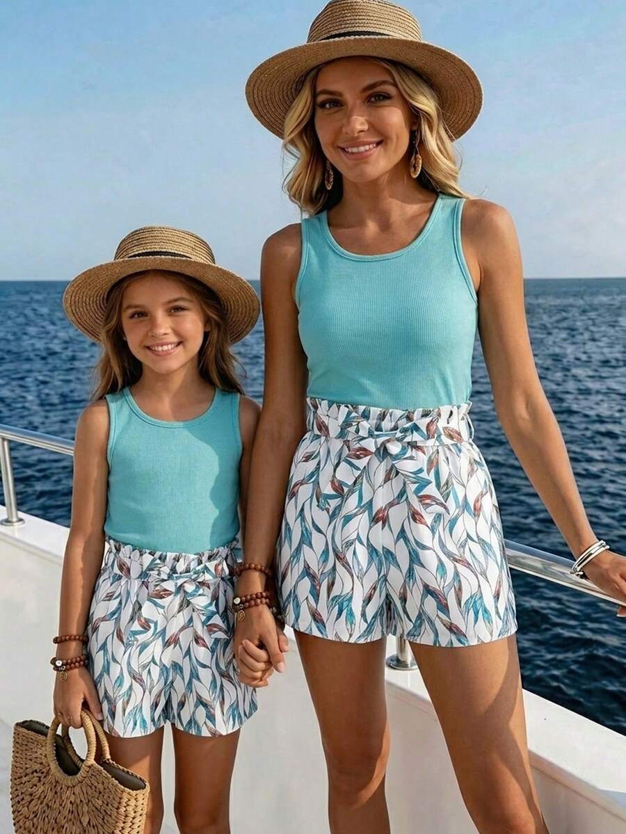 Tween girls 2-piece summer set featuring a turquoise blue ribbed tank top and tropical leaf pattern belted shorts.