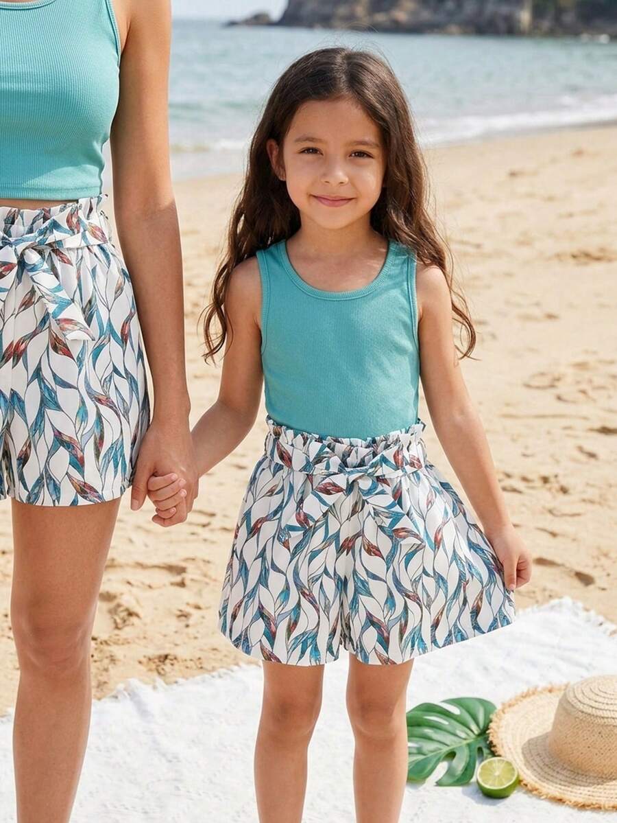 Tween girls 2-piece summer set featuring a turquoise blue ribbed tank top and tropical leaf pattern belted shorts.