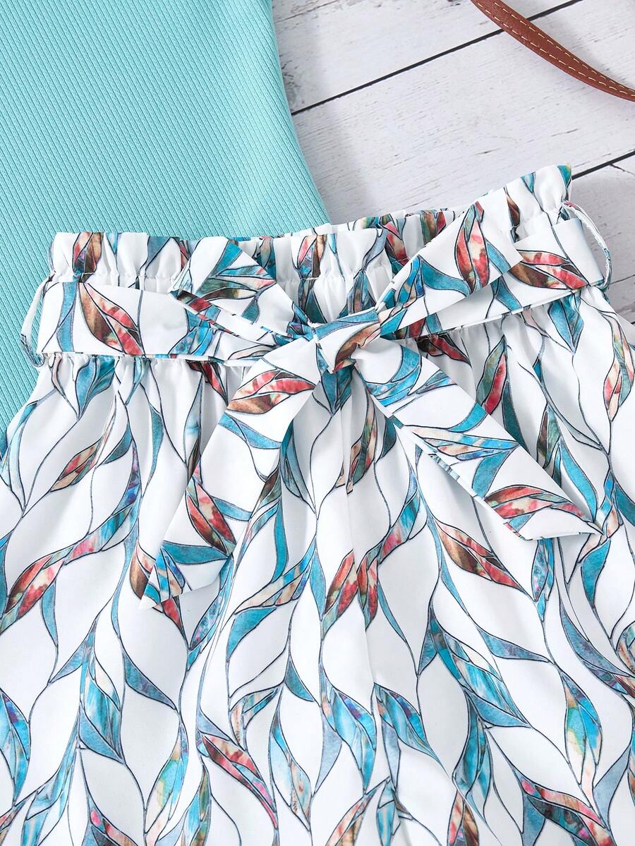 Tween girls 2-piece summer set featuring a turquoise blue ribbed tank top and tropical leaf pattern belted shorts.