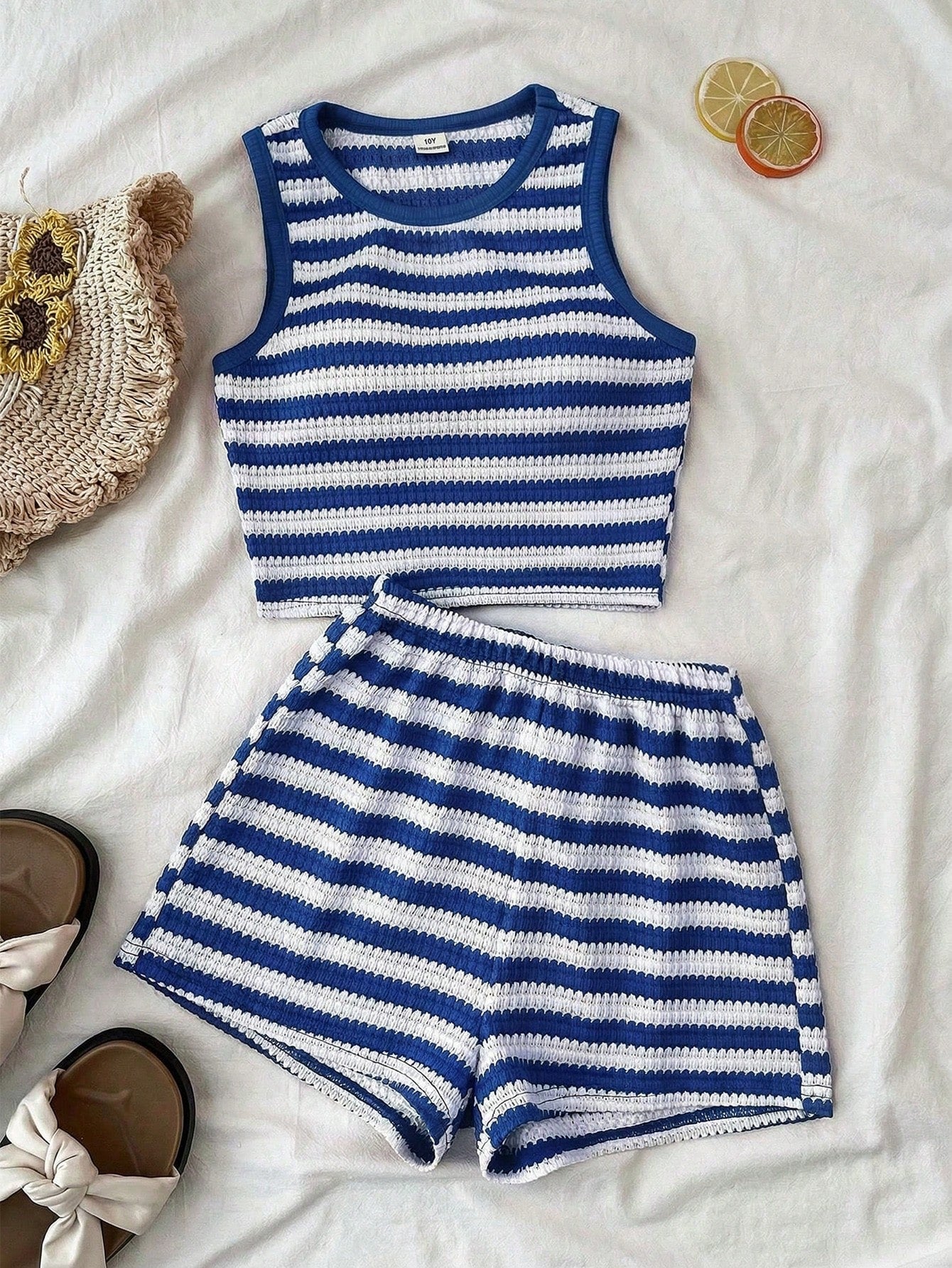 Tween girls black and white two-piece casual summer outfit featuring a rib-knit cropped top with round neck and matching shorts with contrast piping.