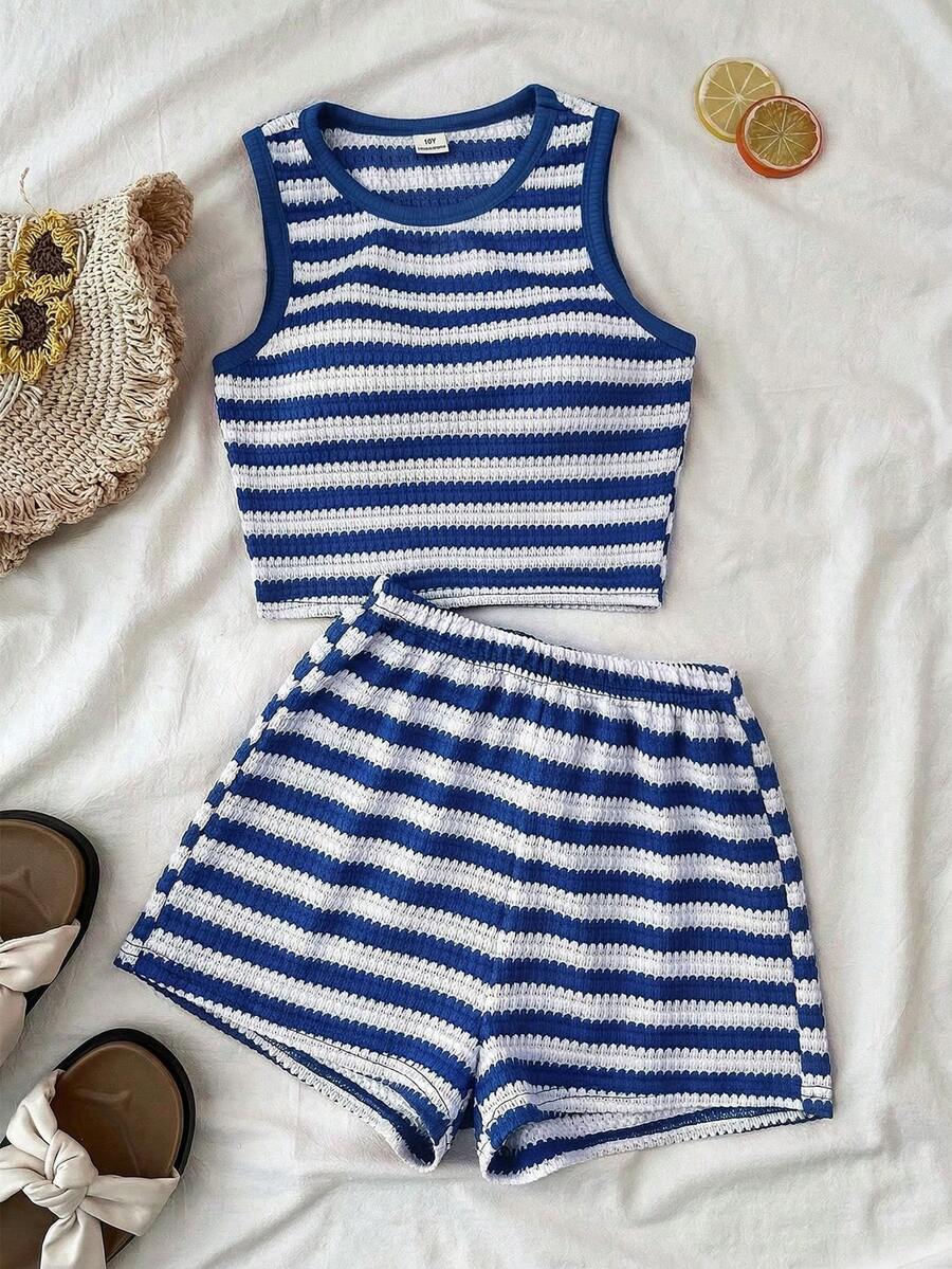 Tween girls black and white two-piece casual summer outfit featuring a rib-knit cropped top with round neck and matching shorts with contrast piping.