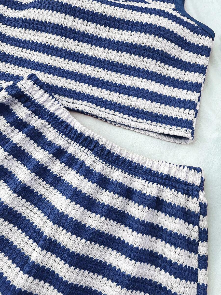 Tween girls black and white two-piece casual summer outfit featuring a rib-knit cropped top with round neck and matching shorts with contrast piping.