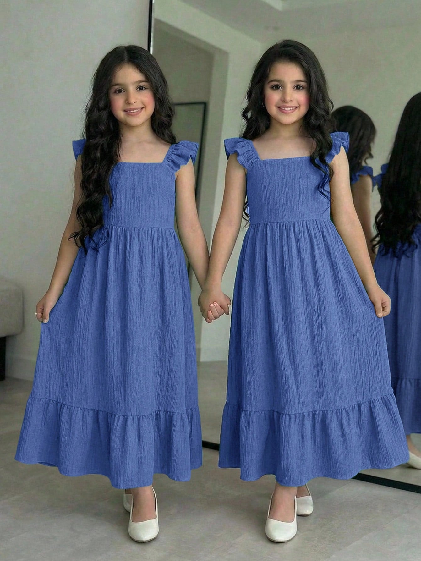 Tween girl multicolor floral vacation dress with square neck, ruffle details, shirred bodice, sleeveless A-line shape, high waist, and flounce hem.