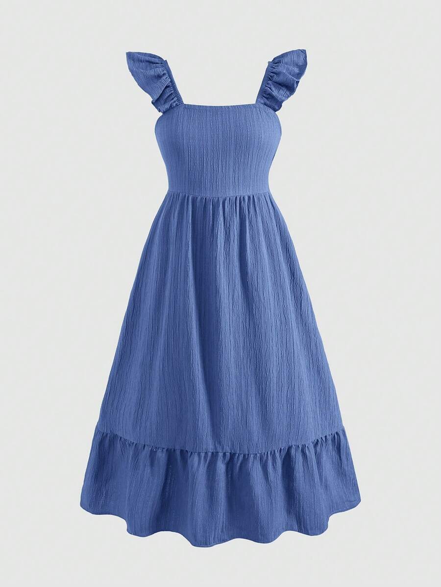 Blue floral print long vacation dress for tween girls featuring an A-line high waist silhouette with ruffle details and spaghetti straps.
