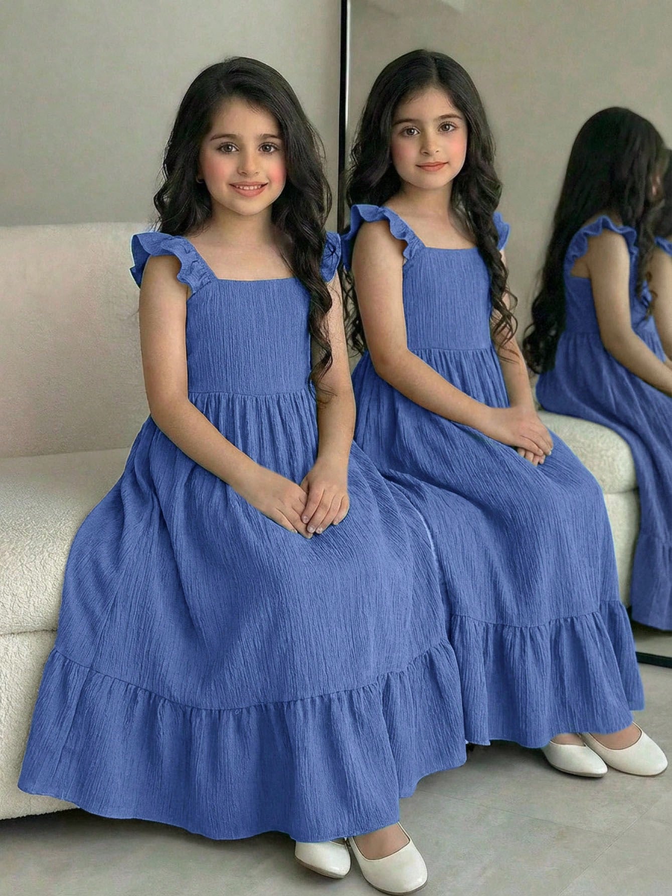 Tween girl multicolor floral vacation dress with square neck, ruffle details, shirred bodice, sleeveless A-line shape, high waist, and flounce hem.