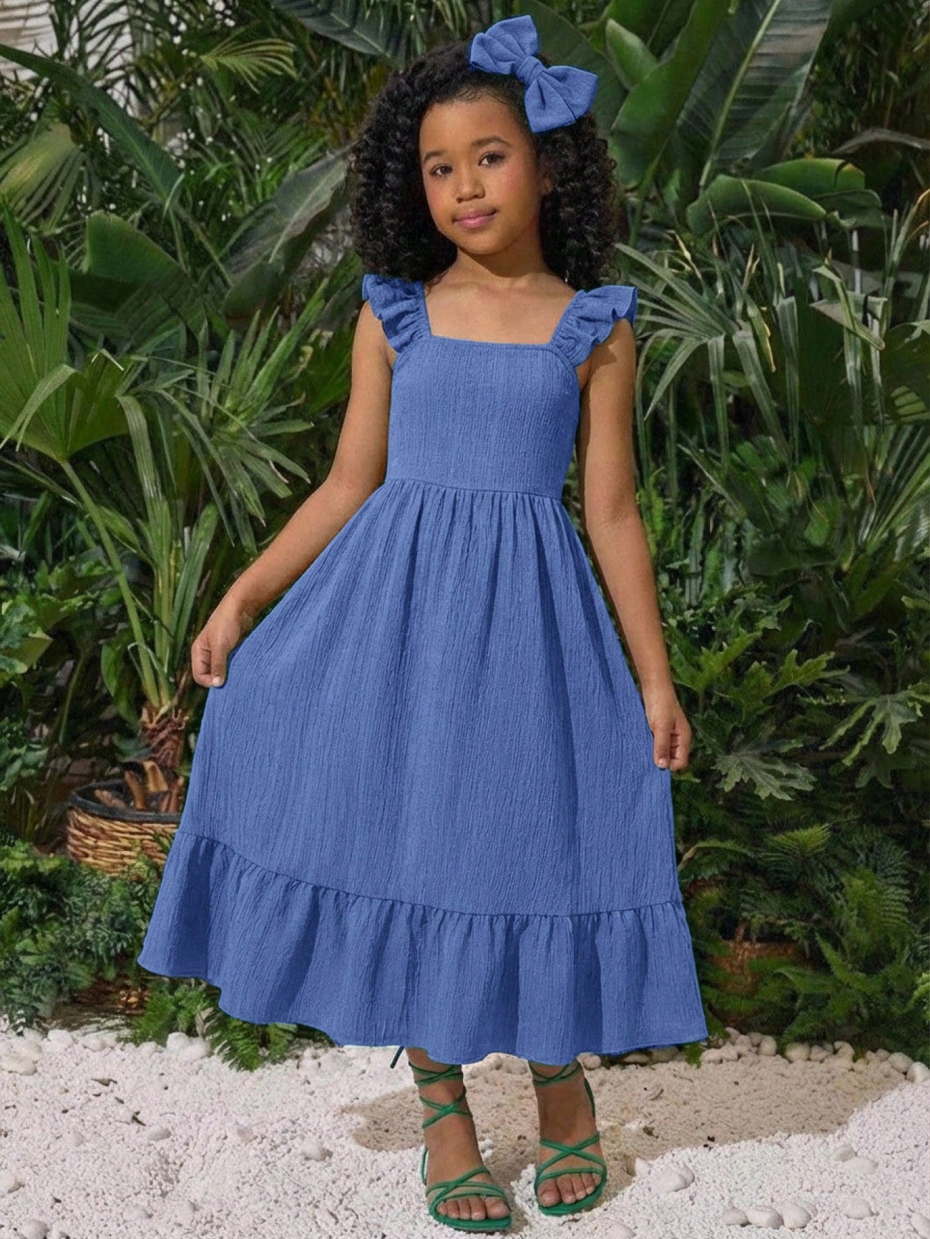 Tween girl multicolor floral vacation dress with square neck, ruffle details, shirred bodice, sleeveless A-line shape, high waist, and flounce hem.