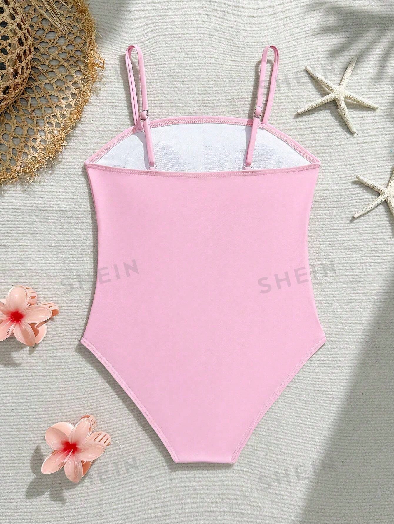 Tween girls one-piece swimsuit with a floral plant print, spaghetti straps, and a mid-waist fit in black.