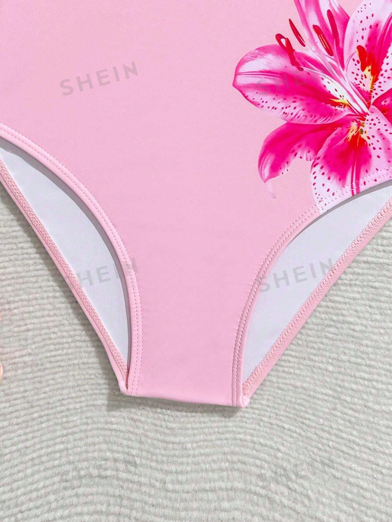 Tween girls one-piece swimsuit with a floral plant print, spaghetti straps, and a mid-waist fit in black.